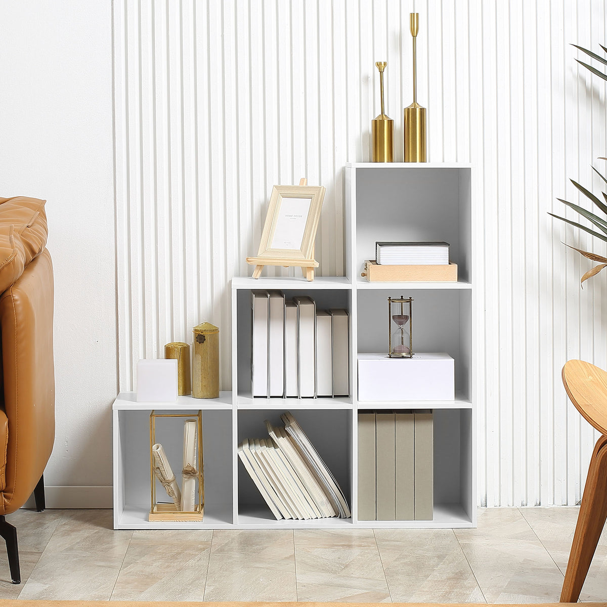 White stepped cube bookcase used to store books and display decor
