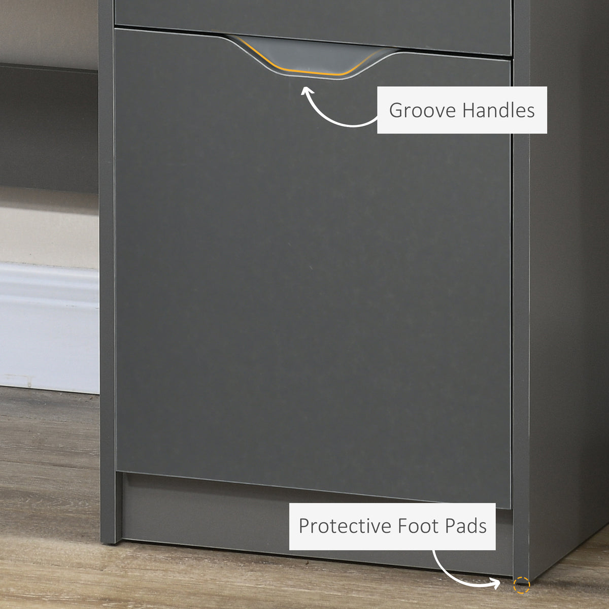 Desk cabinet close-up showing a recessed groove handle and protective foot pad.