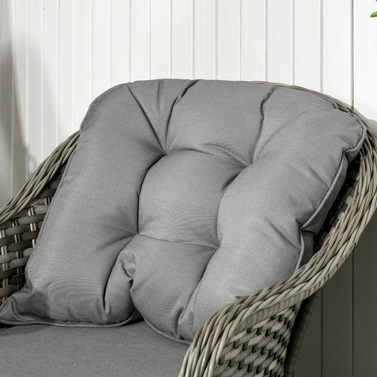Rattan sofa set chair with a thick, tufted grey back cushion