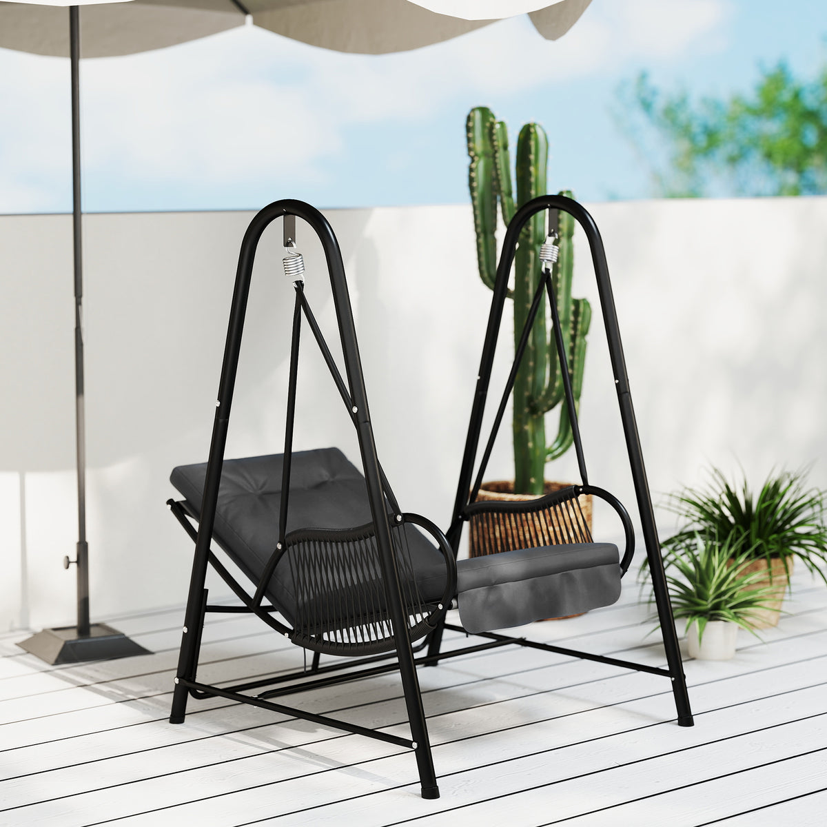 Dark gray rattan hanging swing chair with cushioned seat and black stand