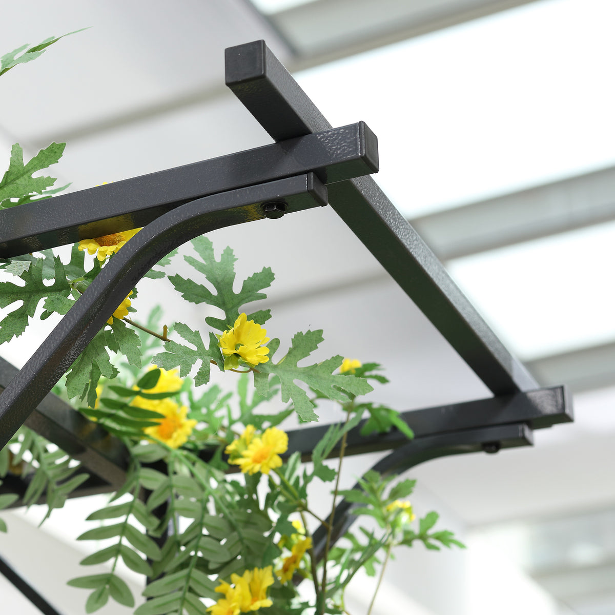 Metal trellis arch crossbars and curved support detail beneath climbing foliage