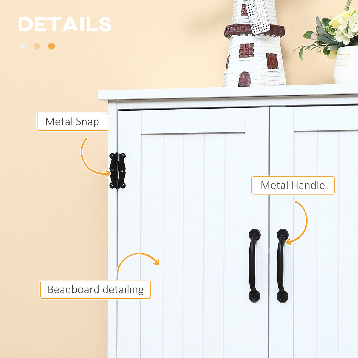 White storage cabinet with beadboard doors, black metal handles and decorative snap hinges.