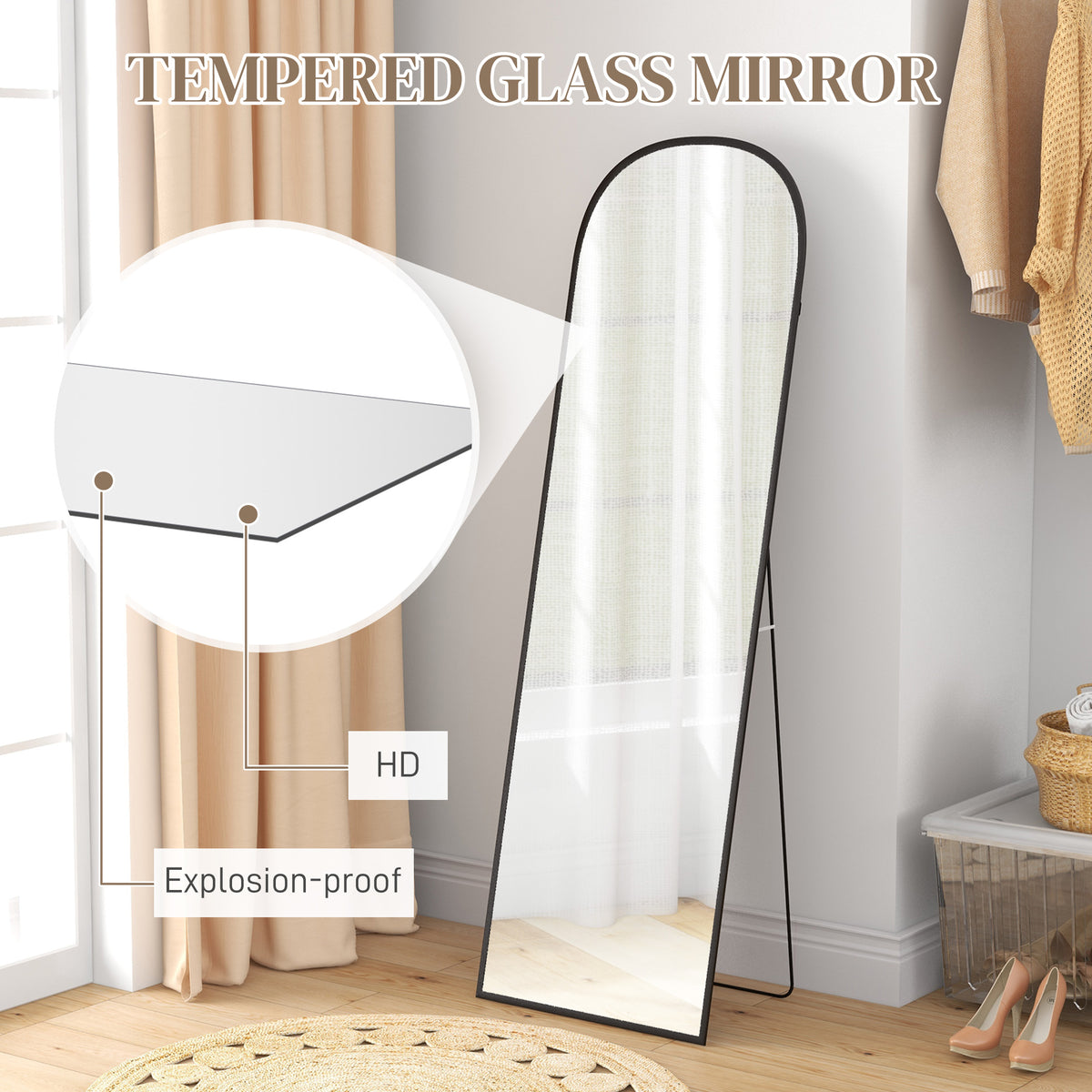 Standing mirror with rounded top, slim black frame and tempered glass.
