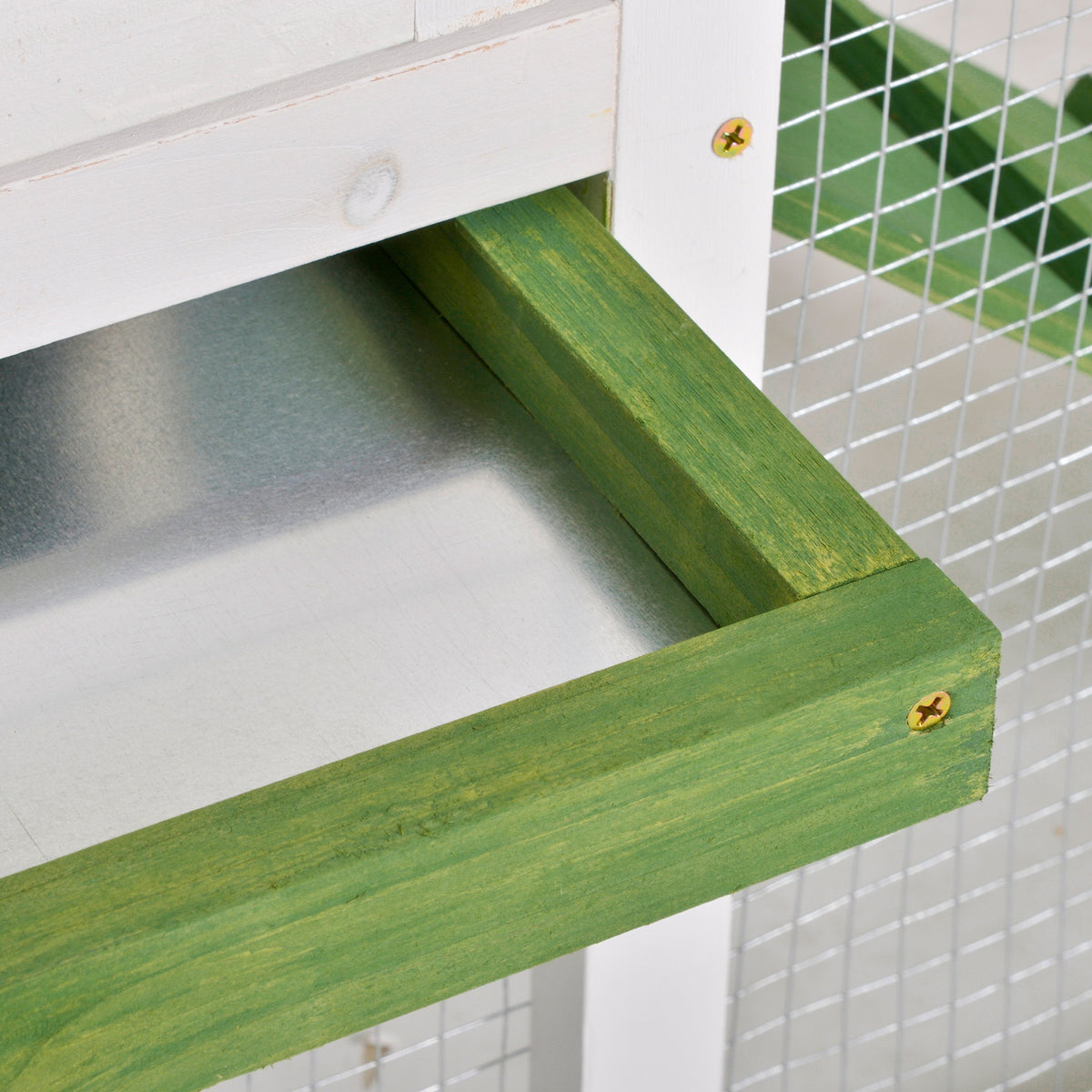 Close-up of the green wooden frame around the metal slide-out tray.