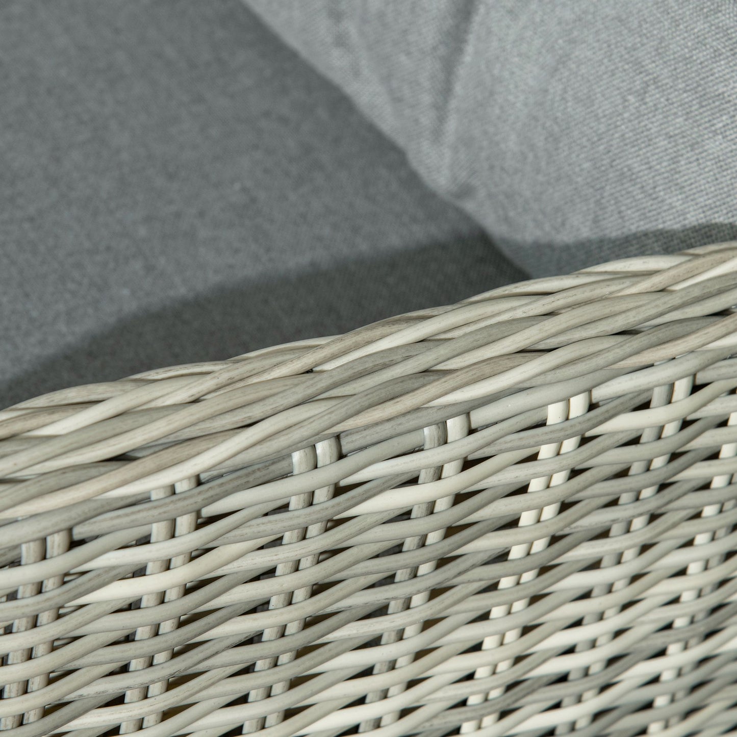 Outsunny rattan chair close-up showing woven wicker edging and gray cushion