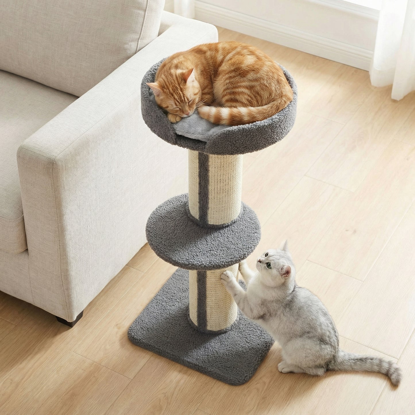 Gray cat tree with sisal posts, padded top bed and middle perch; cats rest and play