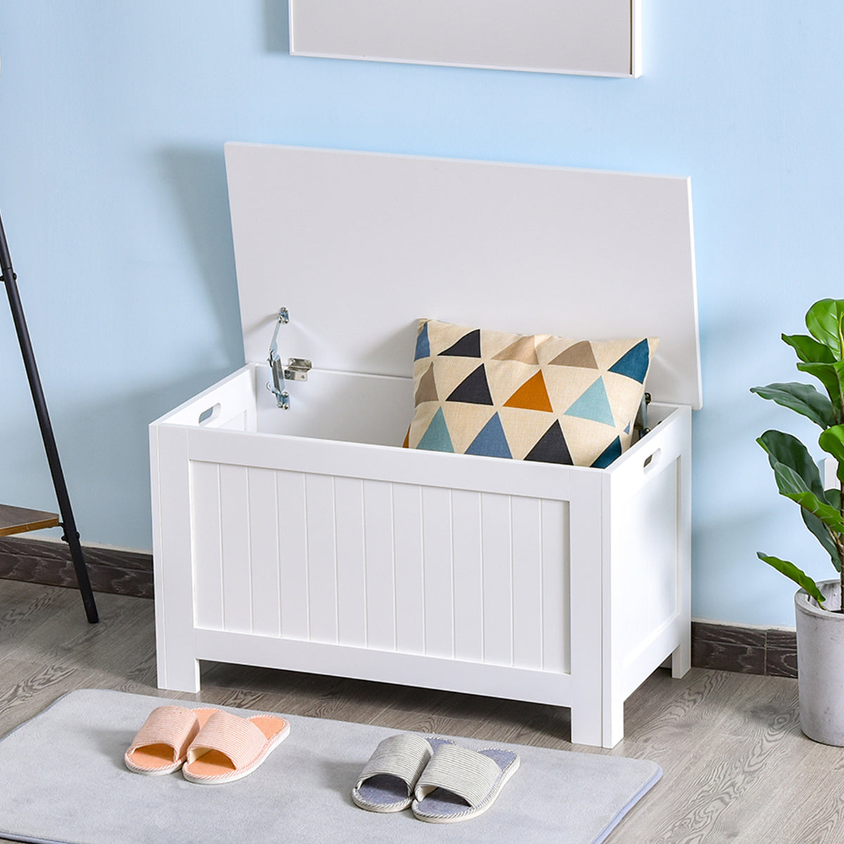 Open white lift-top storage chest with a patterned cushion inside