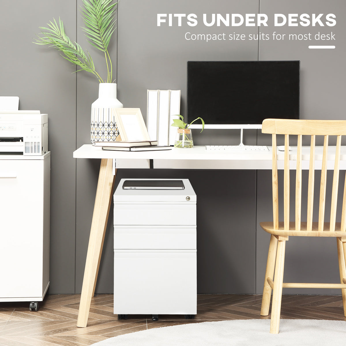 Compact white three-drawer filing cabinet positioned under a desk.