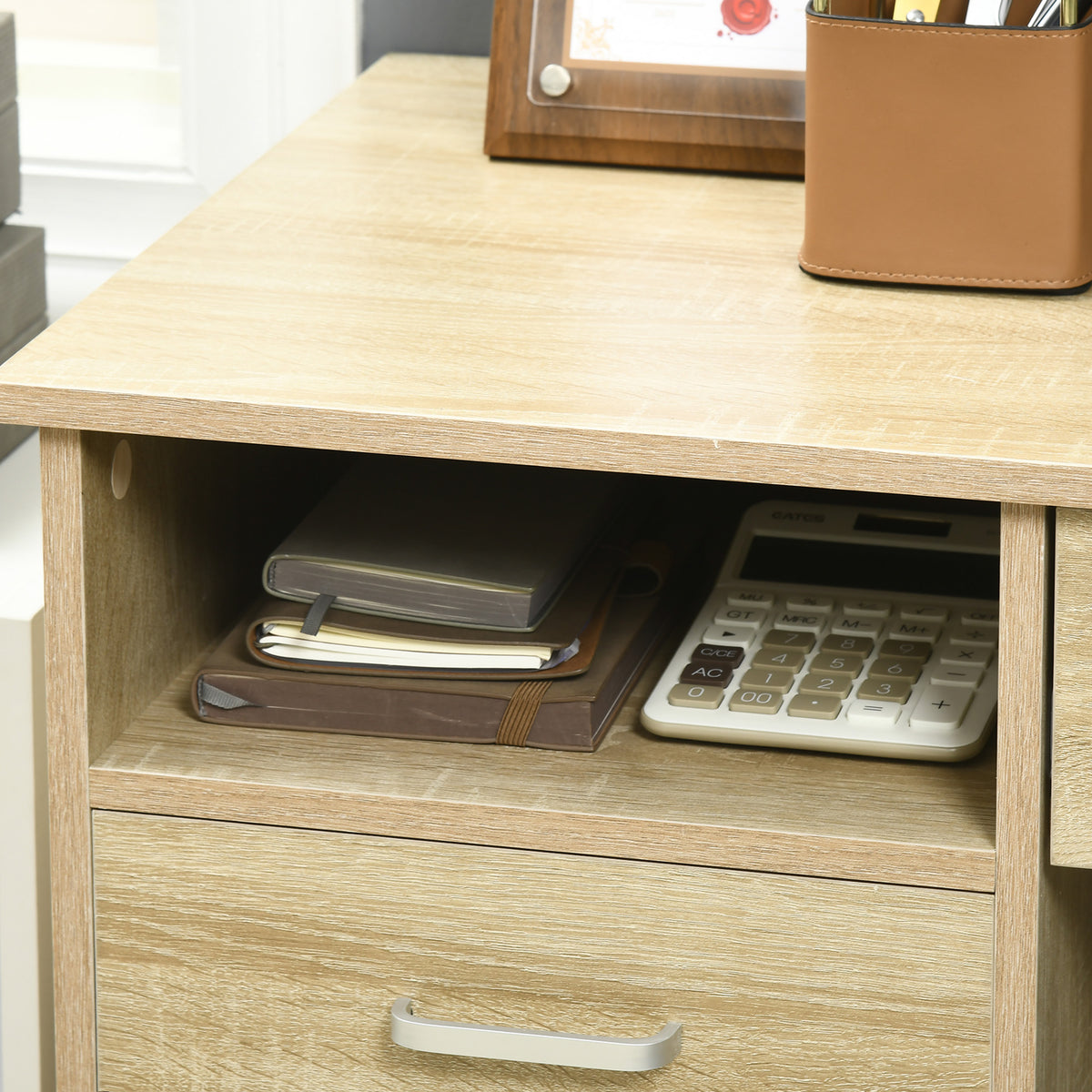 Oak desk shelf and drawer with notebooks and calculator