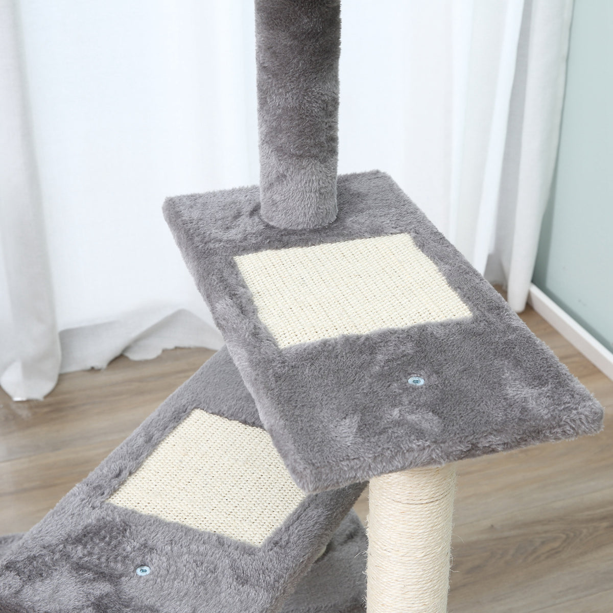 Close-up of grey cat tree platforms with cream sisal scratching pads