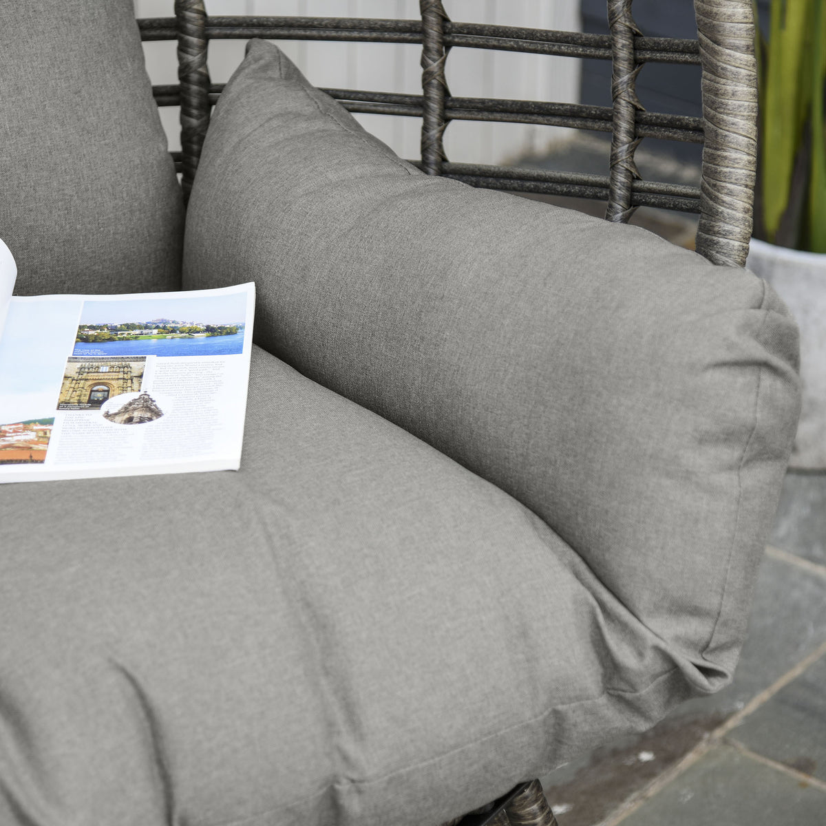 Close-up of gray chair cushions and woven wicker frame