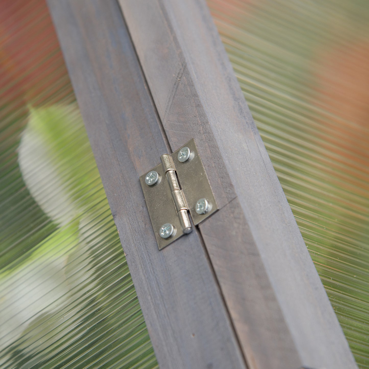 Outsunny cold frame close-up of metal hinge fixed to gray wooden frame