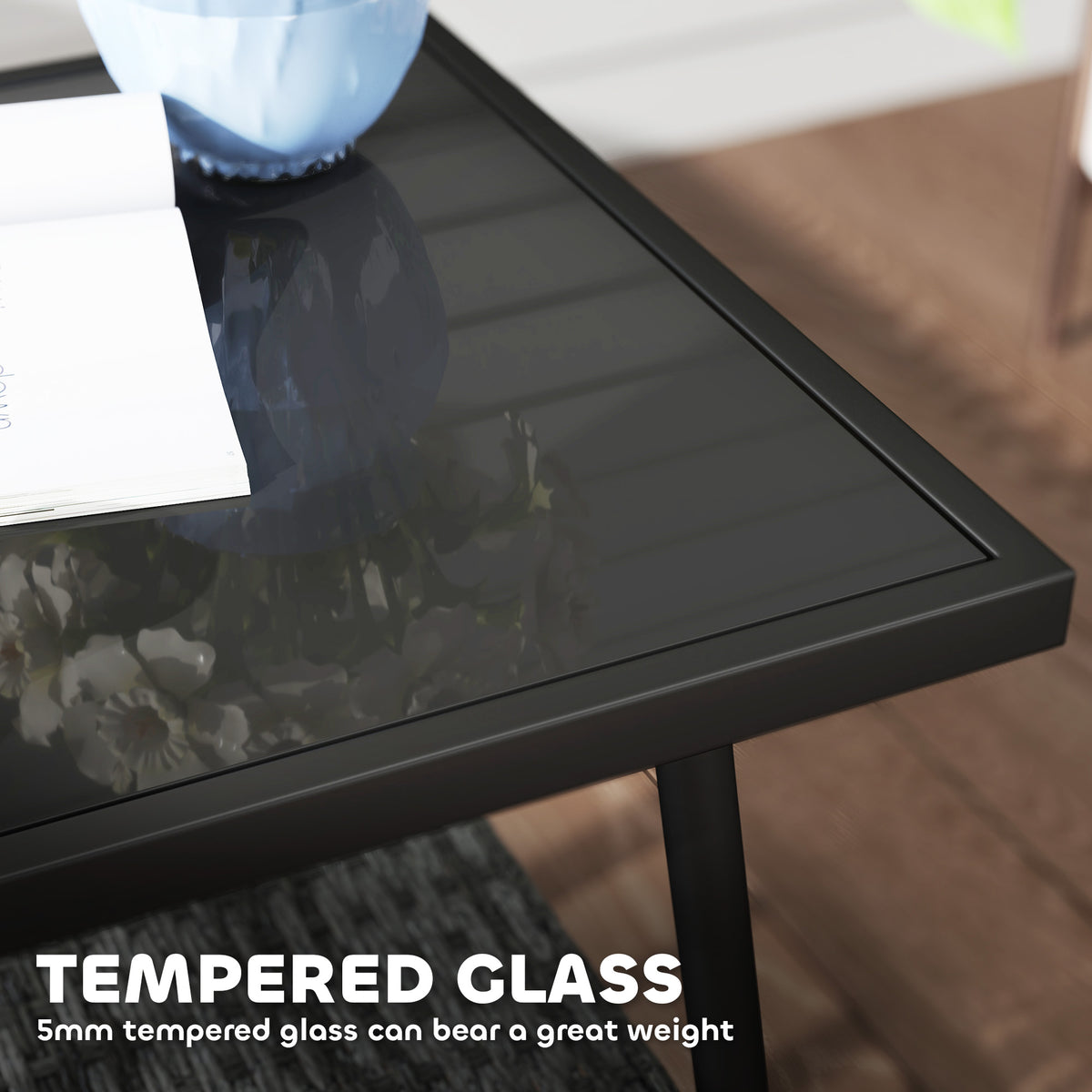 Black-framed bistro table with a tempered glass top