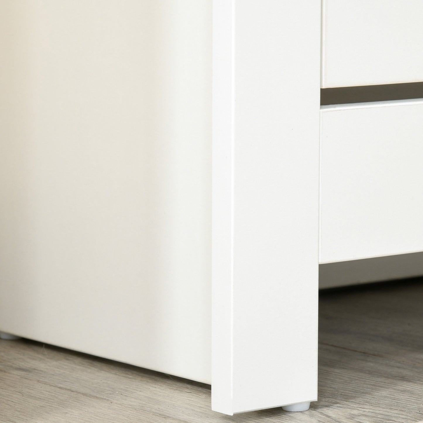 Close-up of the white shoe cabinet's side panel and raised base