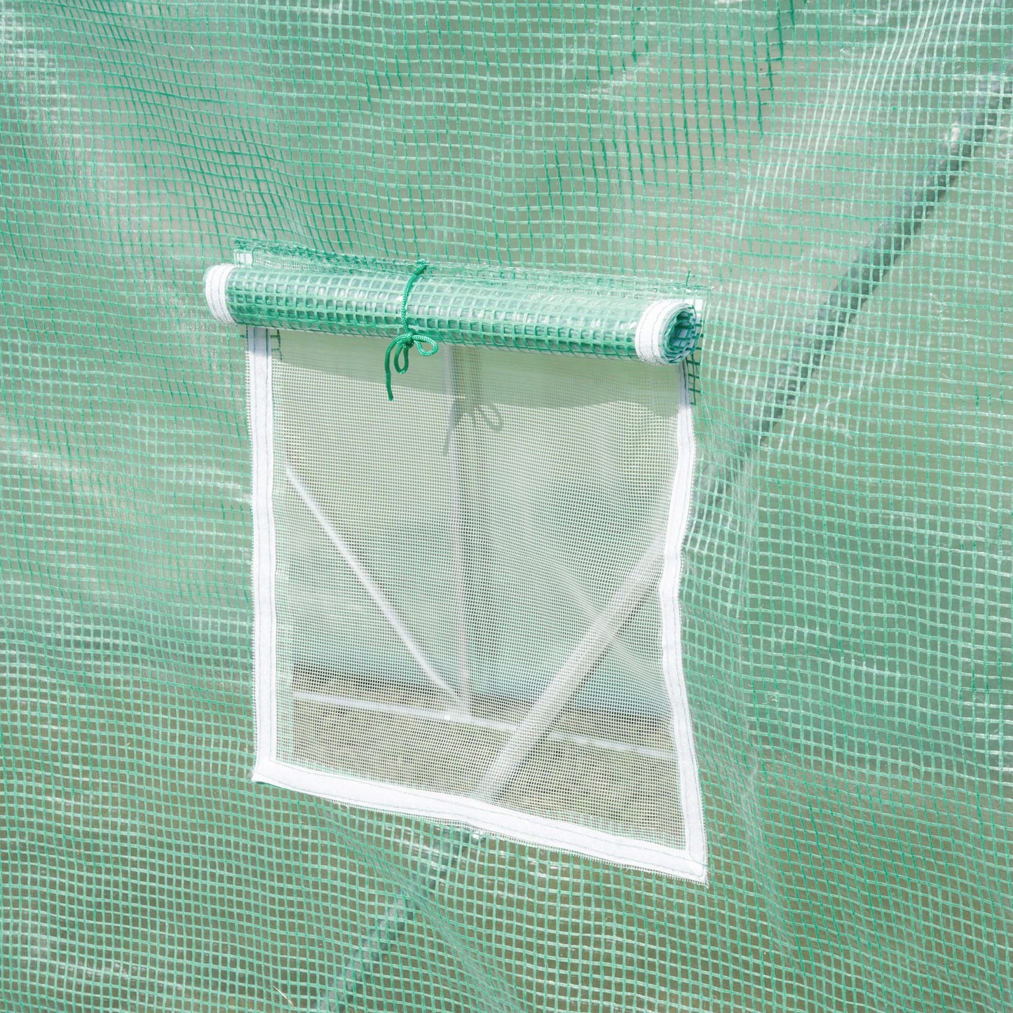 Close-up of a greenhouse roll-up mesh window