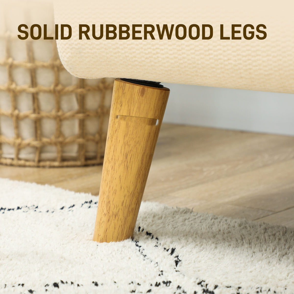 Loveseat detail showing a tapered solid rubberwood leg beneath cream fabric upholstery