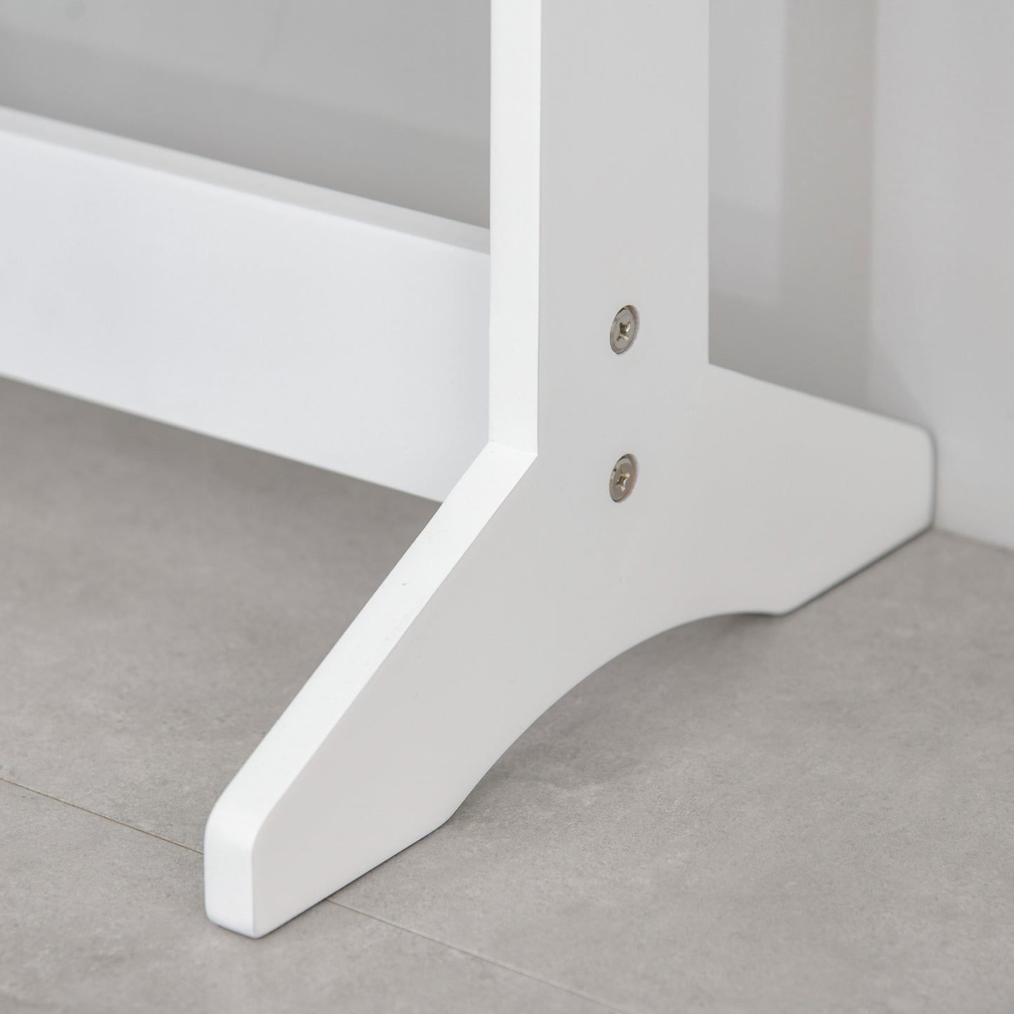 Close-up of the white cabinet's floor stand base and fasteners.
