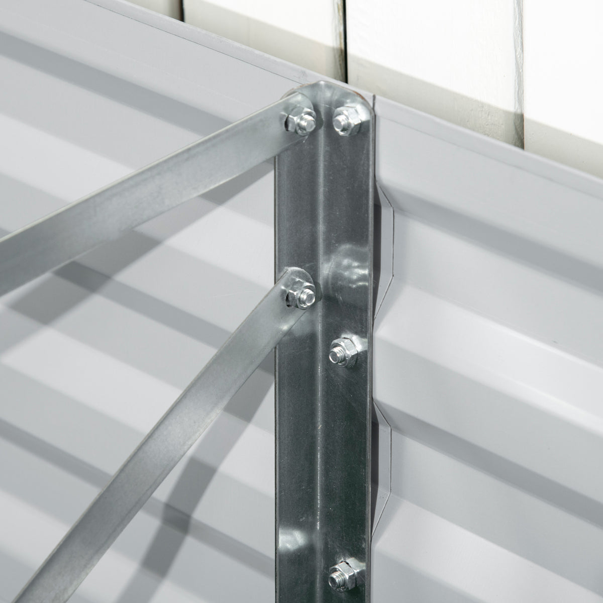 Raised bed steel reinforcement bracket secured with bolts