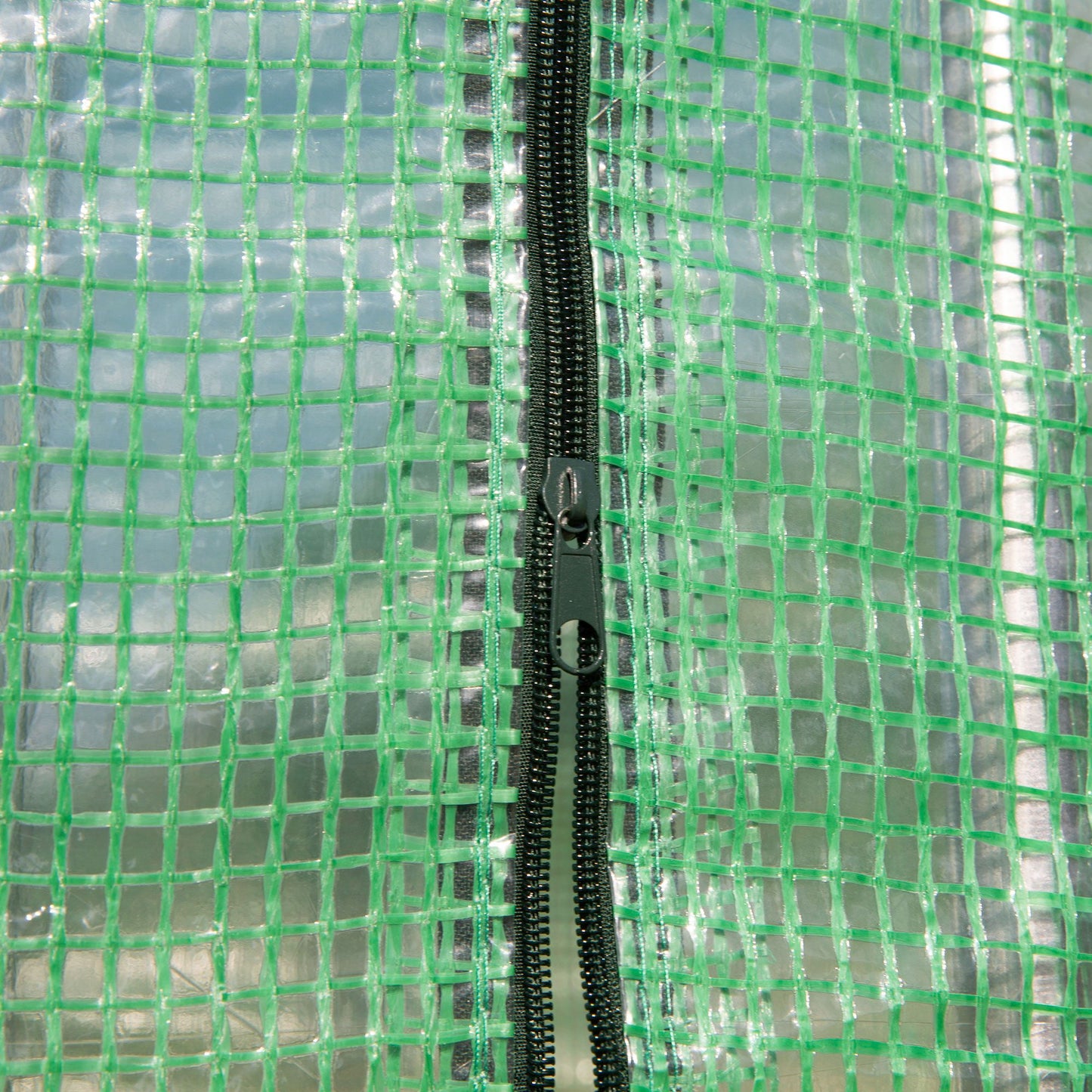 Greenhouse PE cover close-up showing its mesh fabric and zipper.