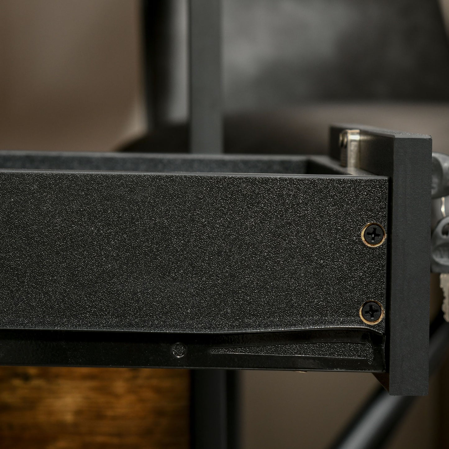 Close-up of the black filing cabinet's drawer construction and metal fasteners.