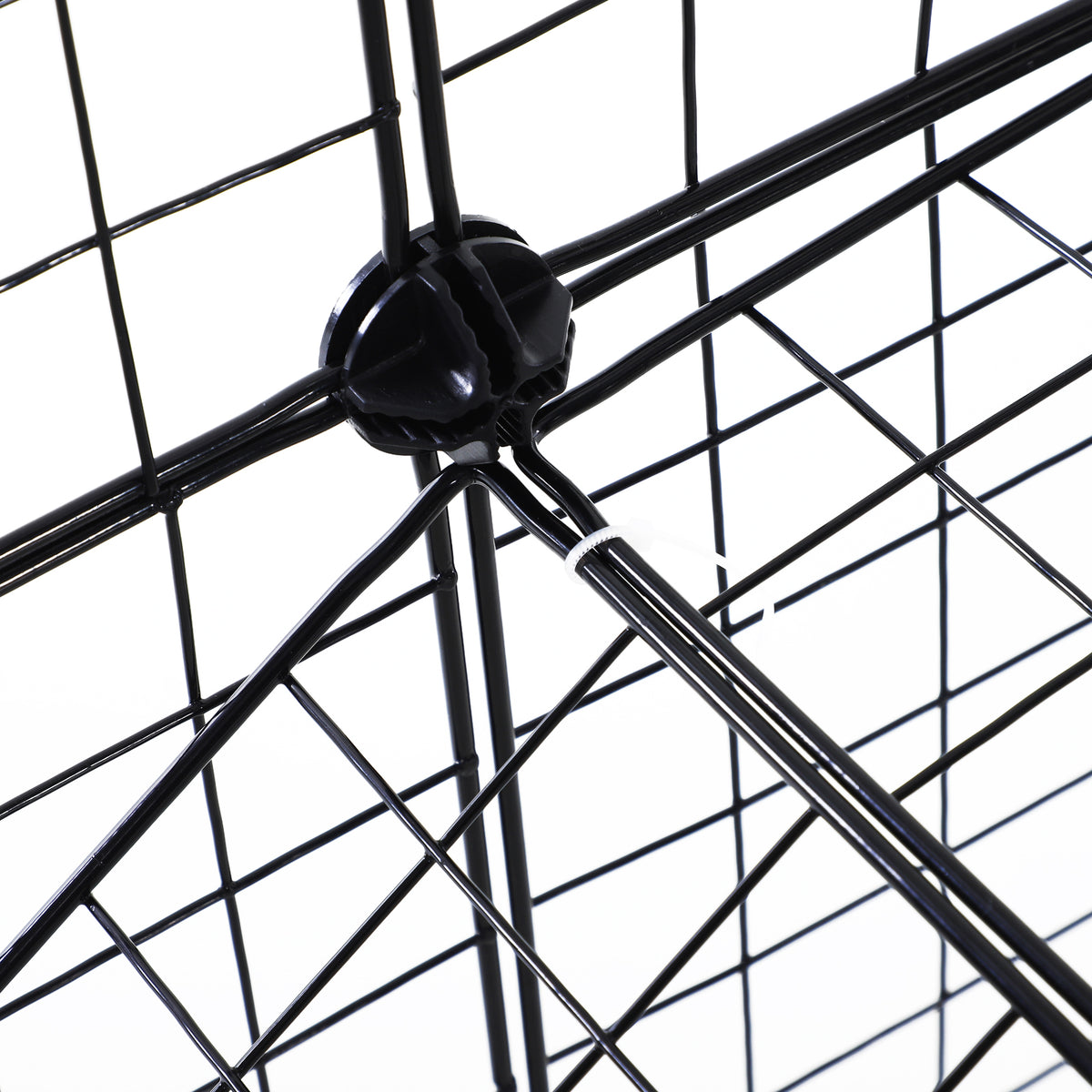 Close-up of black plastic connectors joining the wire playpen panels