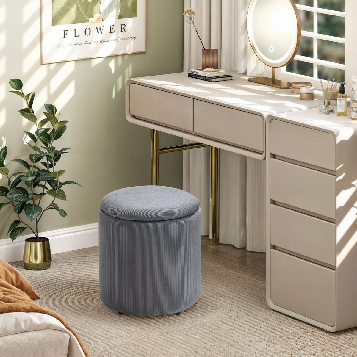 Grey corduroy storage ottoman with a round padded lid