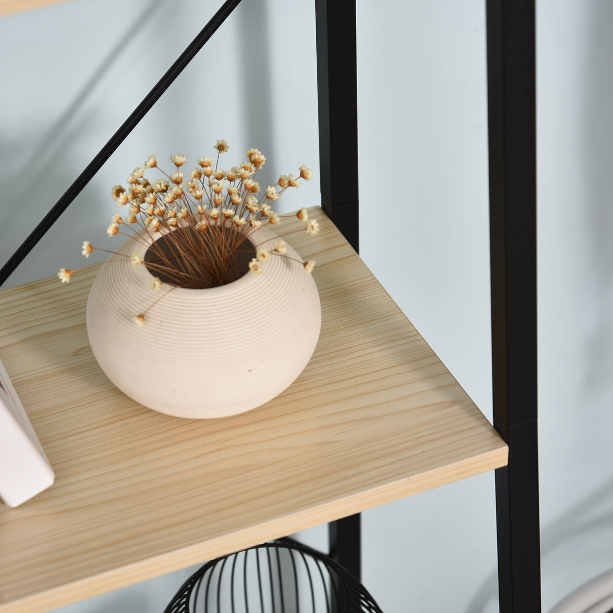 Close-up of an oak-tone HOMCOM shelf surface and black metal frame
