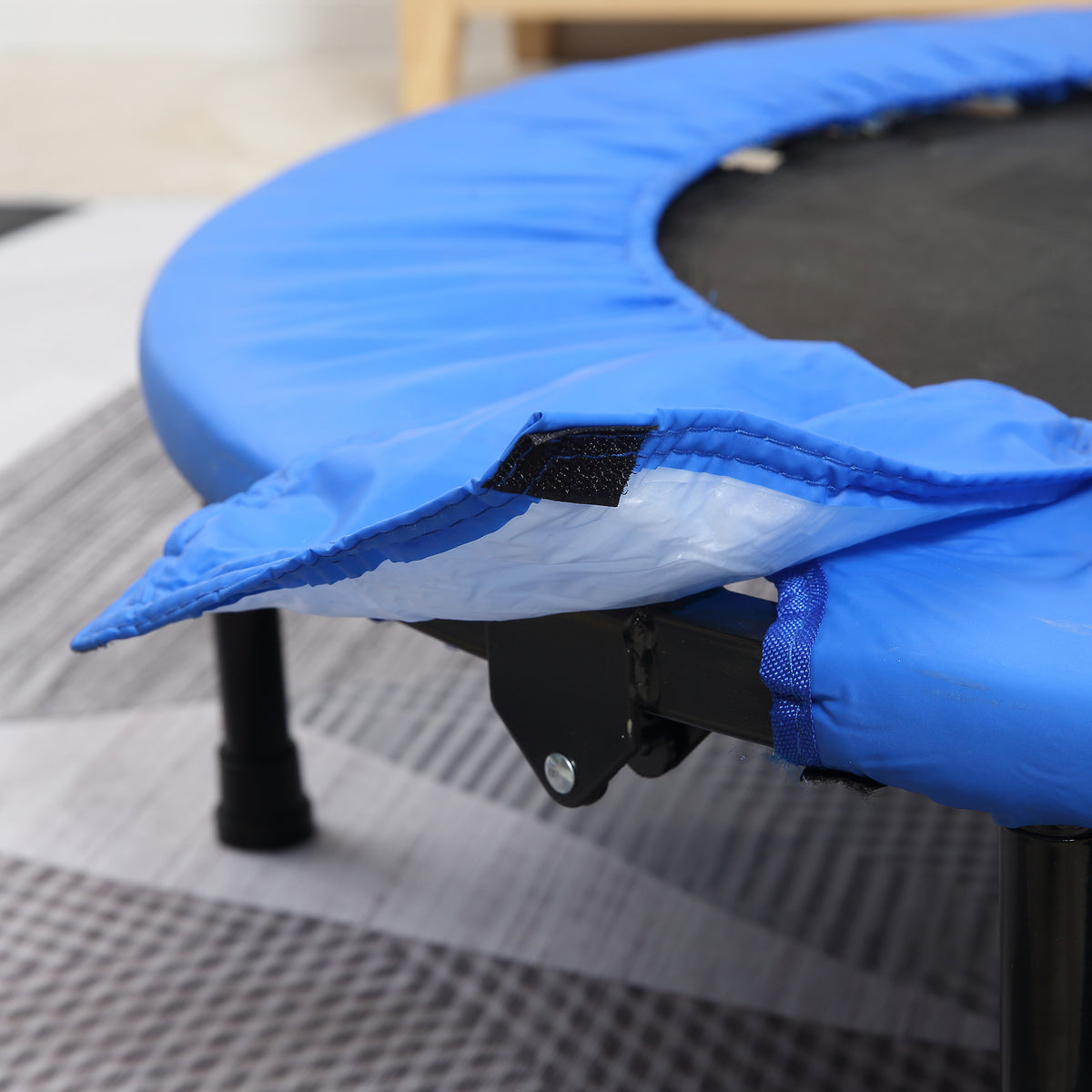 HOMCOM trampoline close-up of the blue safety pad fastener and metal frame
