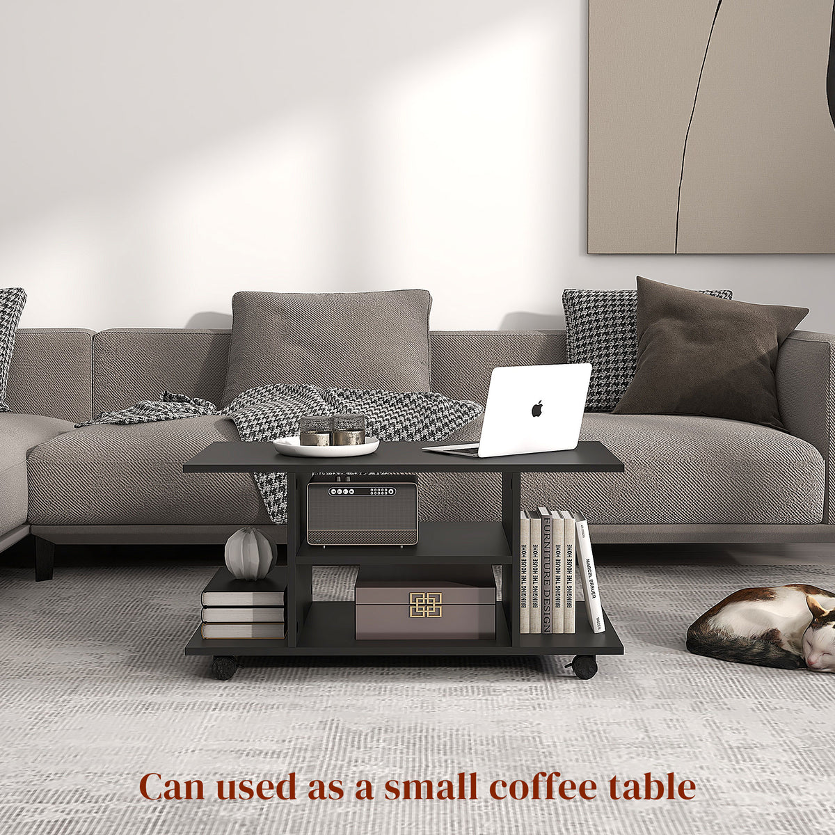 Black rolling TV stand used as a coffee table, with open shelves for books and storage