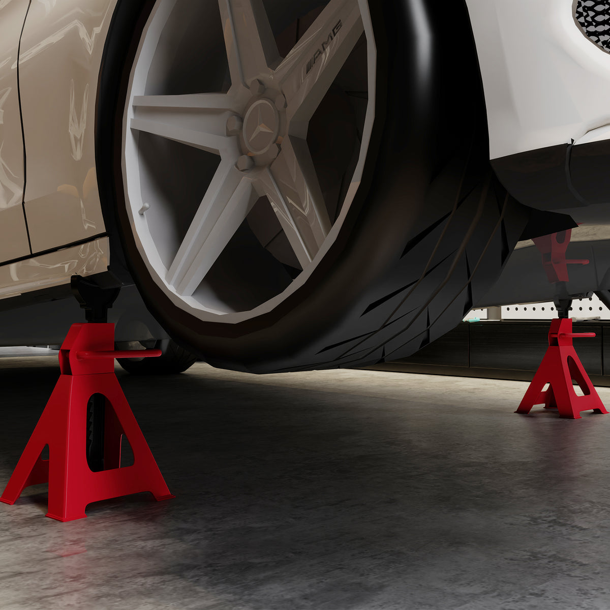 Red jack stands supporting a vehicle near its wheel