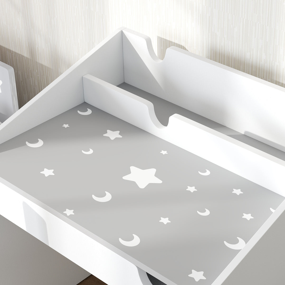 Close-up of gray desktop with white moon and star pattern and raised side panels