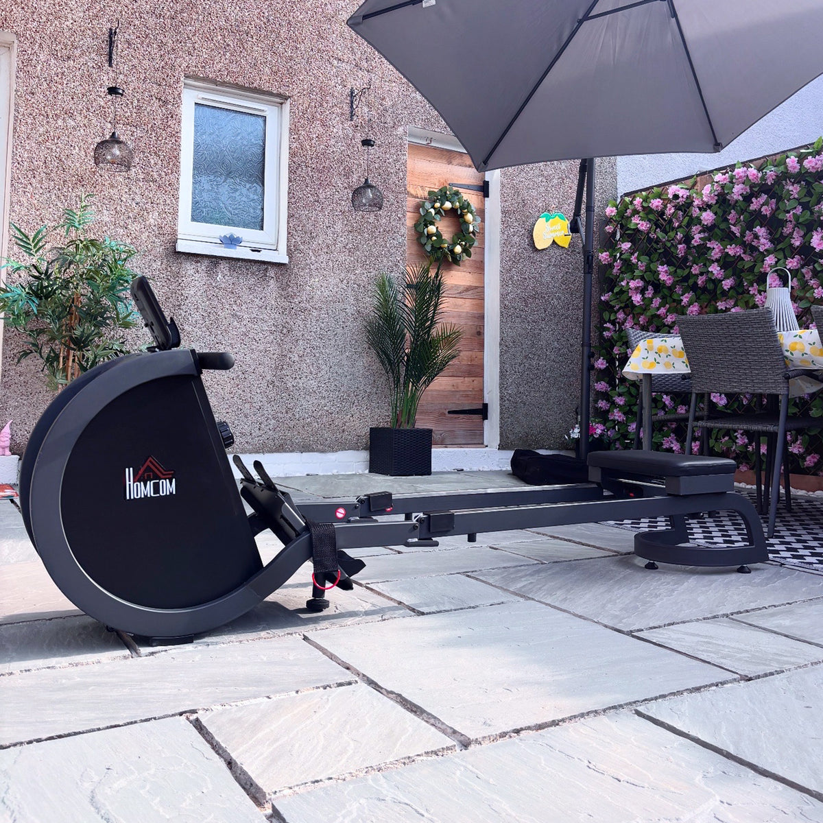 HOMCOM black rowing machine with padded seat, foot pedals and digital monitor