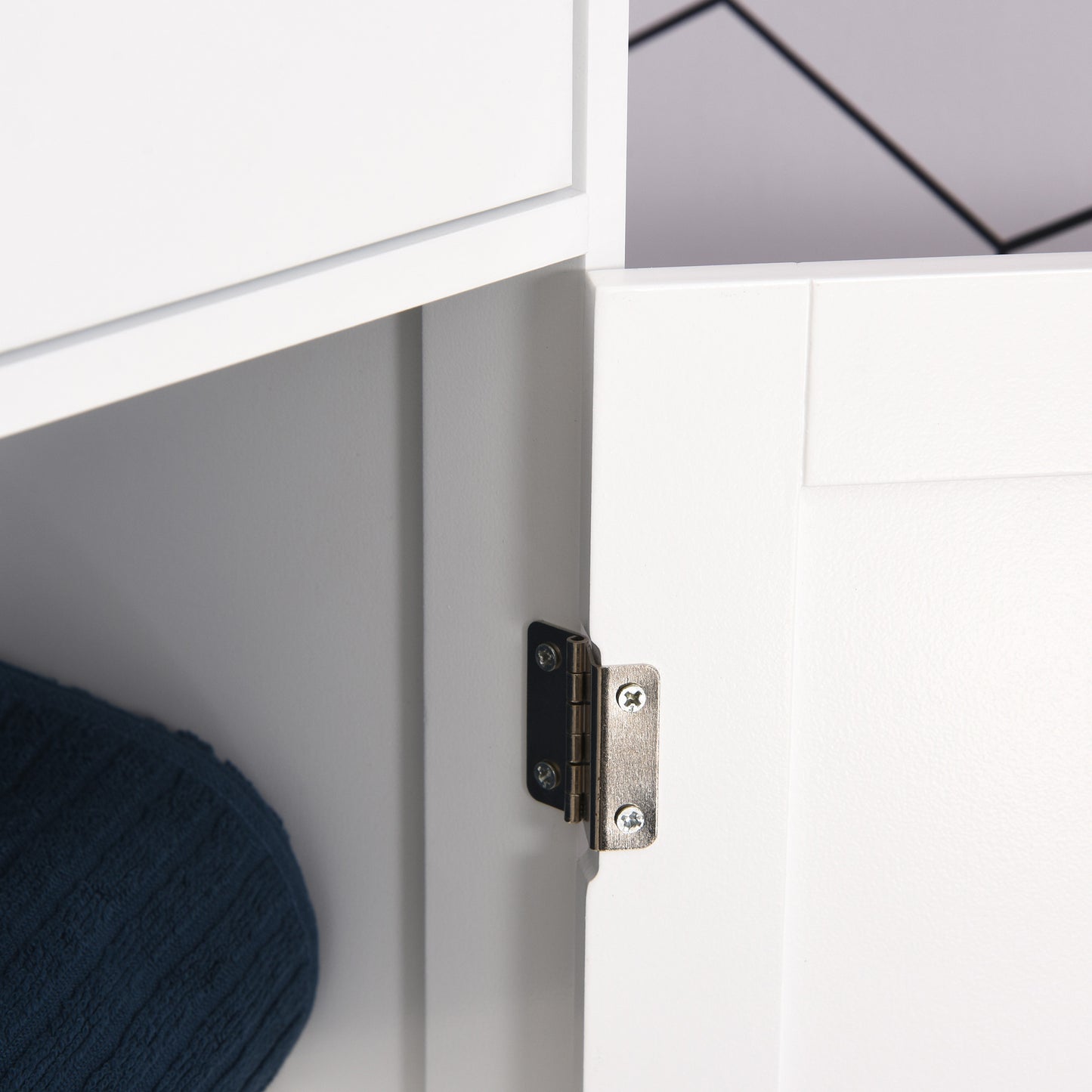 White bathroom cabinet door hinge close-up