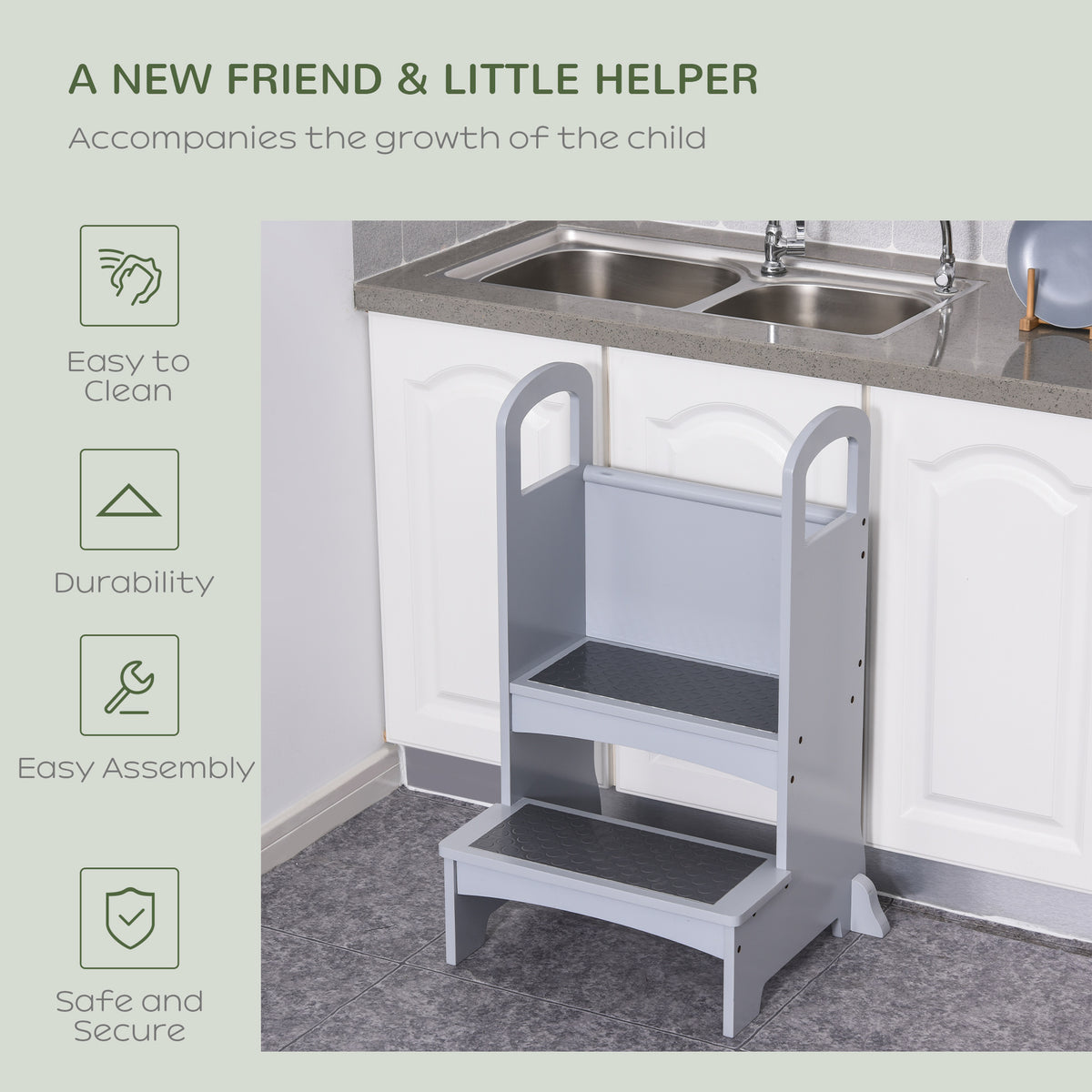 Grey toddler kitchen helper stool positioned at a kitchen counter