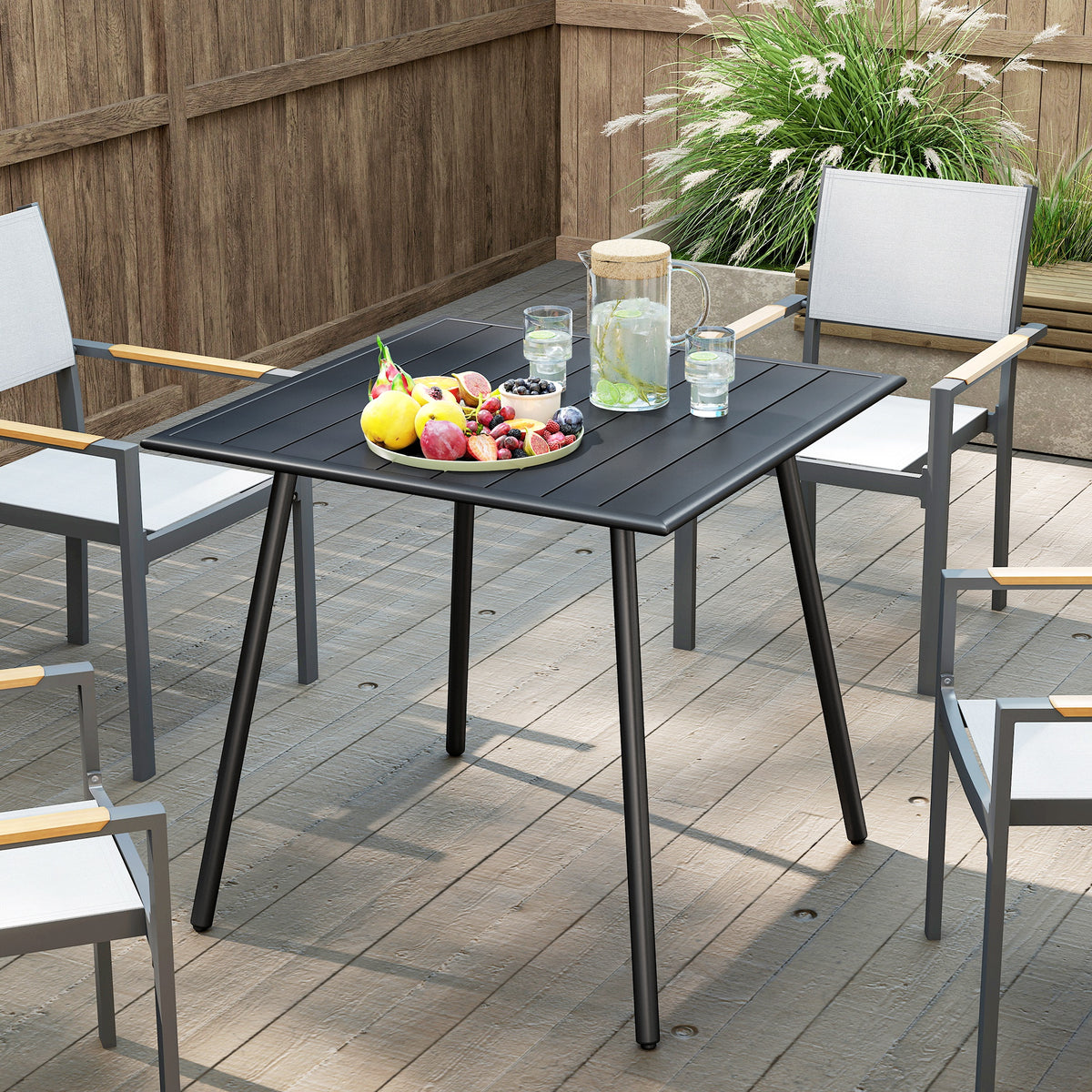 Outsunny black square garden table with slatted top, shown with outdoor dining chairs