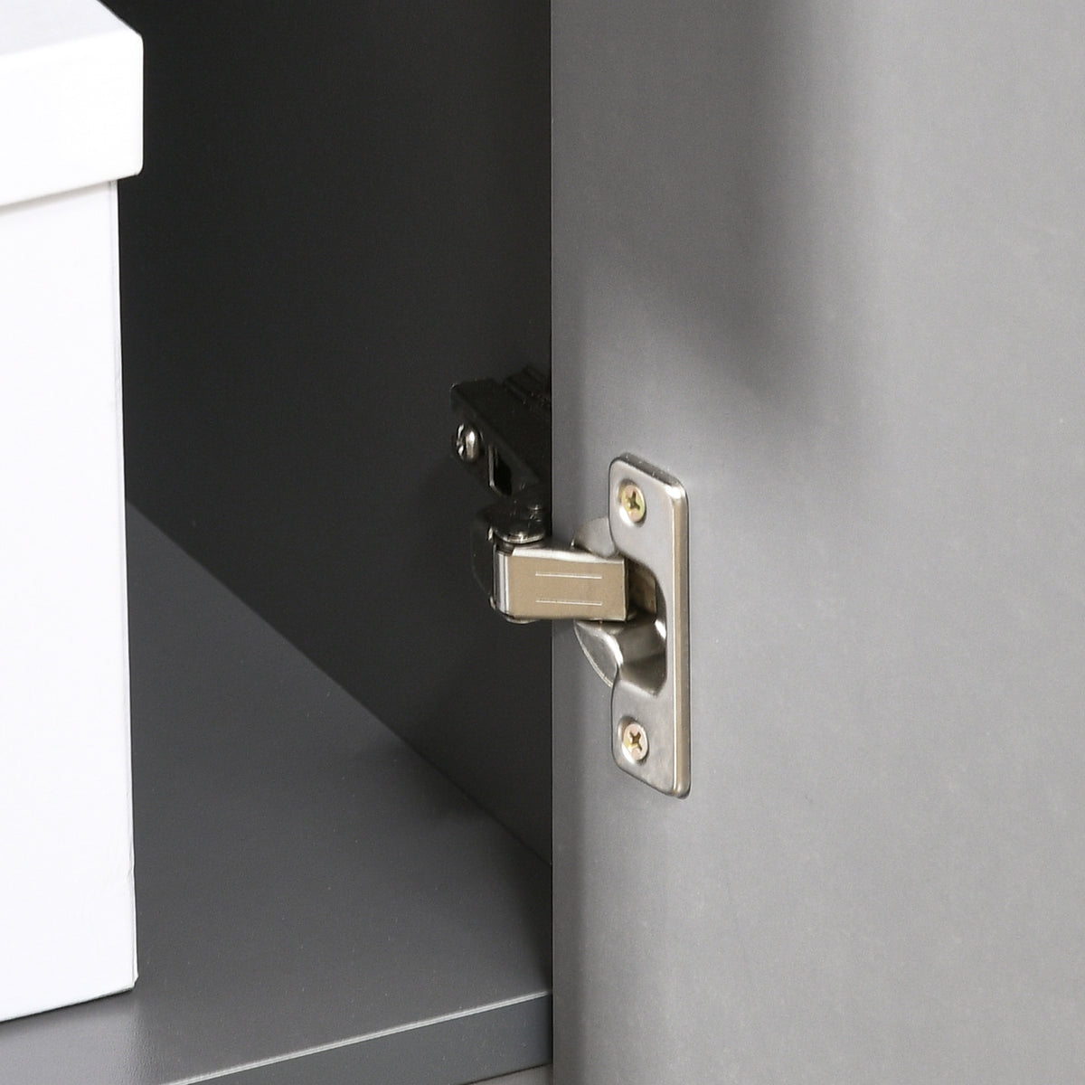 Close-up of the desk cabinet's metal door hinge.