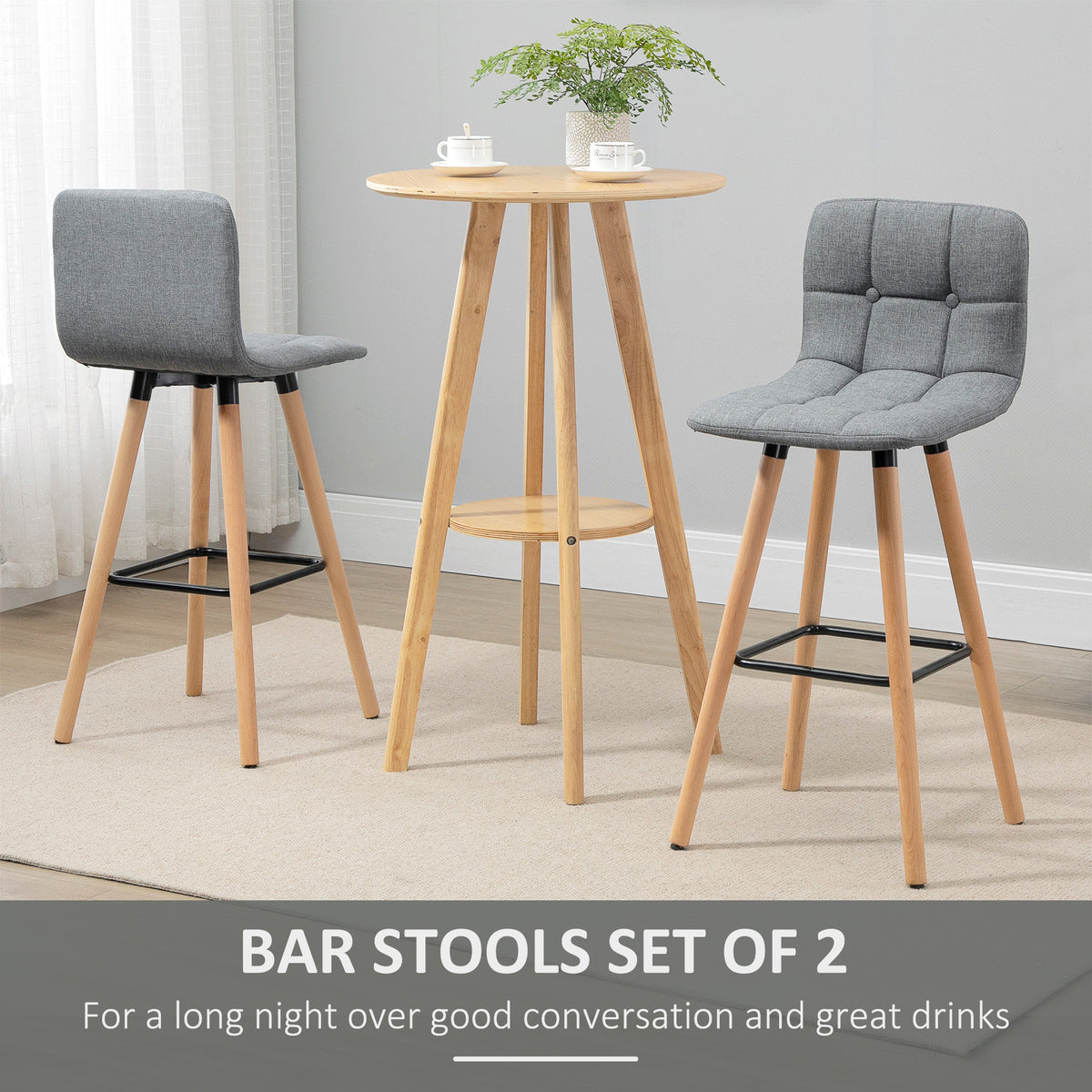 Pair of gray button-tufted bar stools with wood legs and black footrests