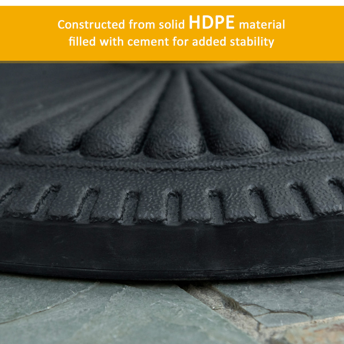 Close-up of the textured edge of a black cement-filled HDPE parasol base