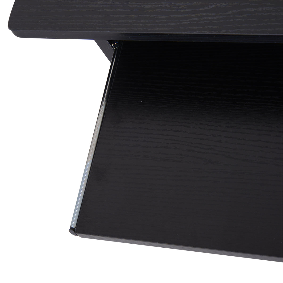 Close-up of the black desk's pull-out keyboard tray and tabletop edge