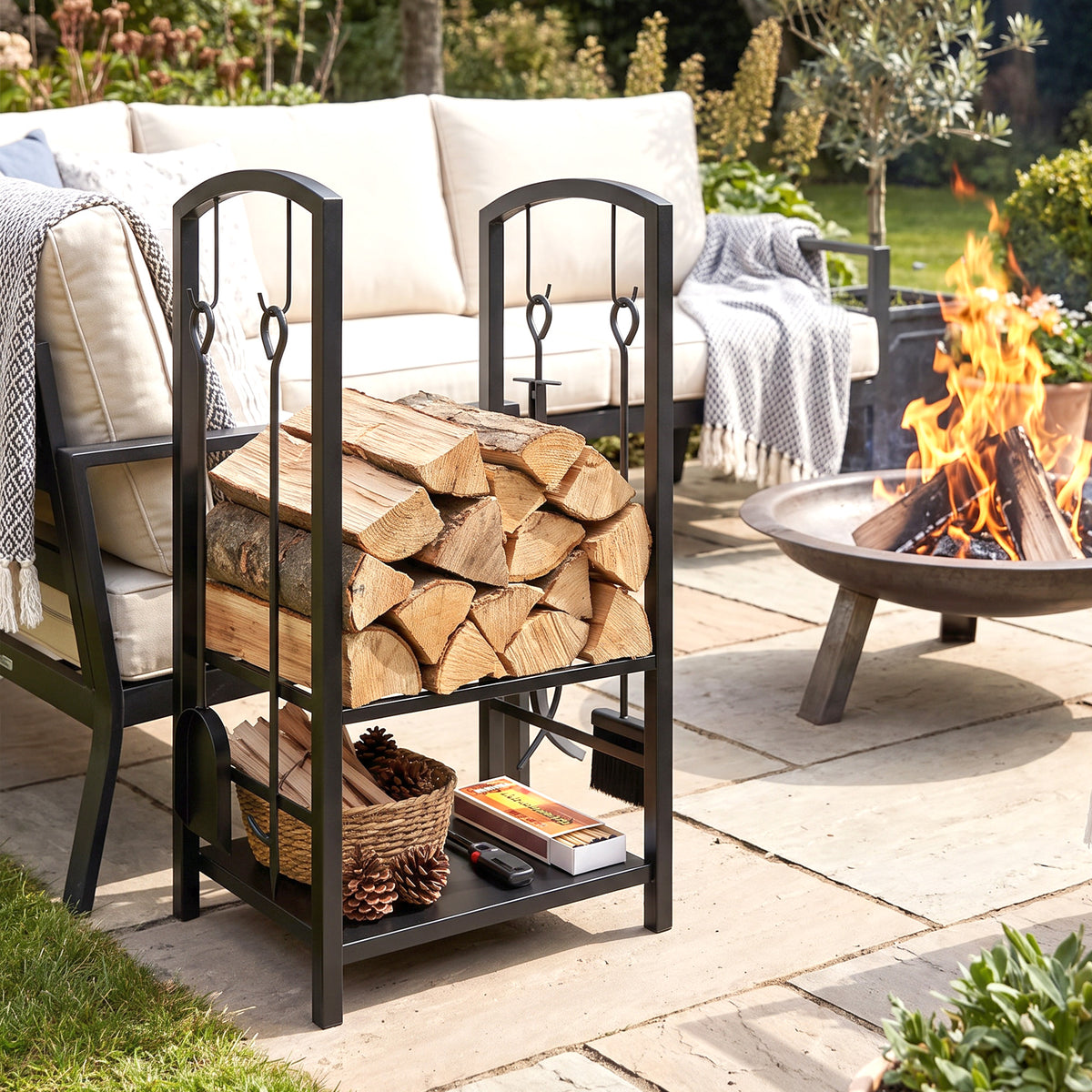 Black two-tier metal firewood rack holding logs and kindling