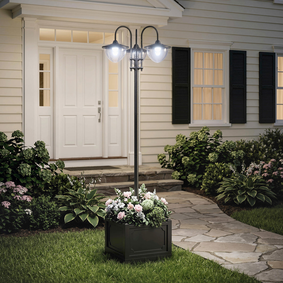 Three-head solar lamp post with a flower-filled square planter base