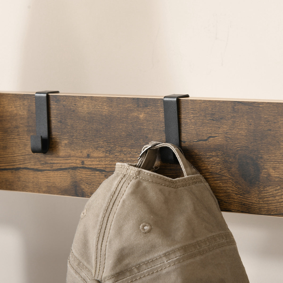 HOMCOM coat rack wood panel with removable black hooks holding a cap