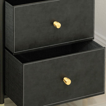 Close-up of two open drawers with black faux leather fronts and gold-tone knobs