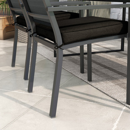 Outsunny black seat cushions tied onto outdoor dining chairs