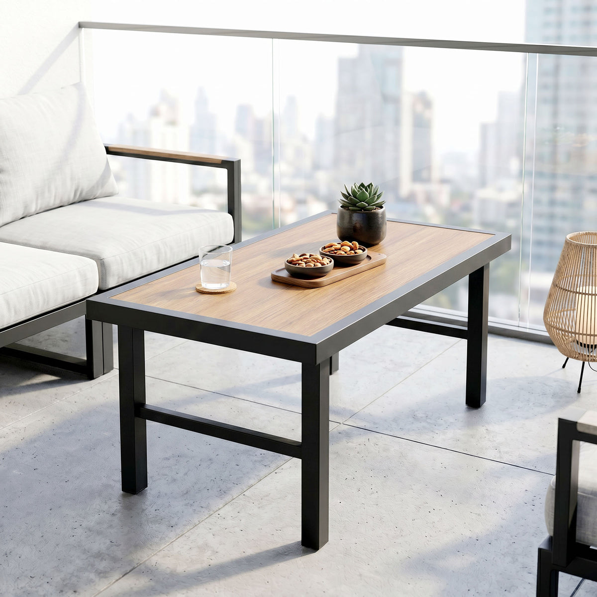 Outsunny coffee table with a brown woodgrain top and black frame on a balcony