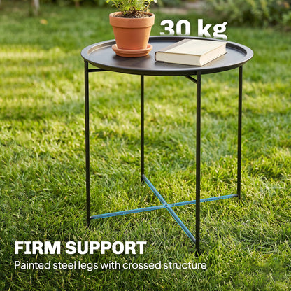 Outsunny black steel tray table with crossed leg supports, holding a plant and book