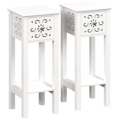 White floral cut-out side tables with drawers and lower shelves, shown as a pair