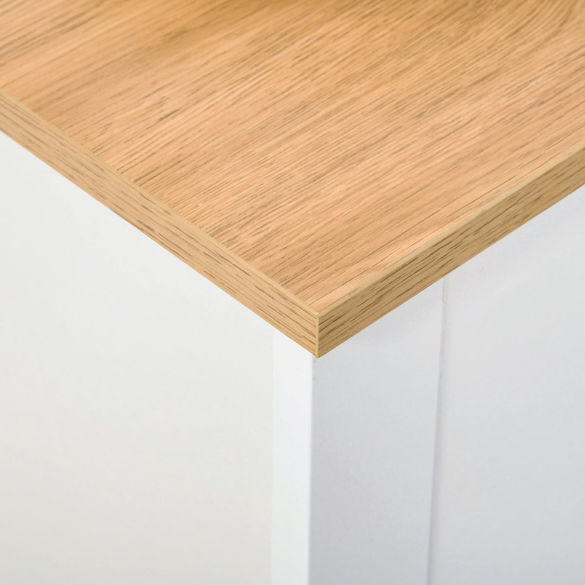 Close-up of the shoe cabinet's wood-look top and white corner construction