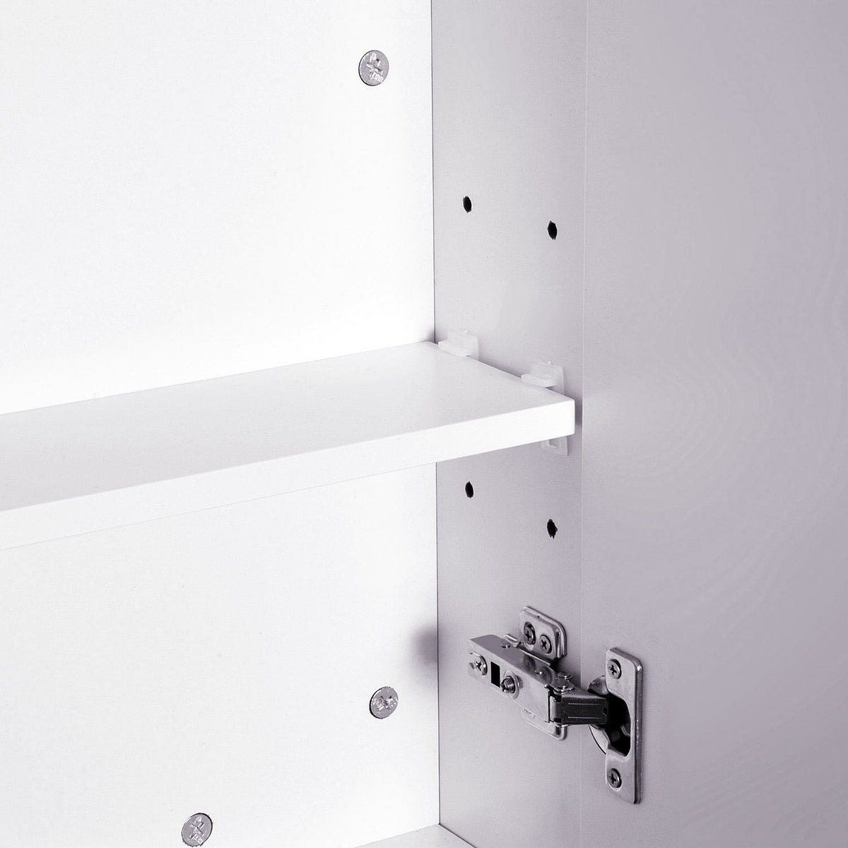 Close-up of a bathroom cabinet shelf adjustment holes and metal hinge