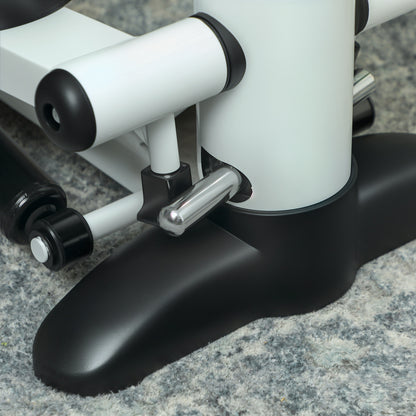 Close-up of the mini stepper's white frame, metal linkage, and black base